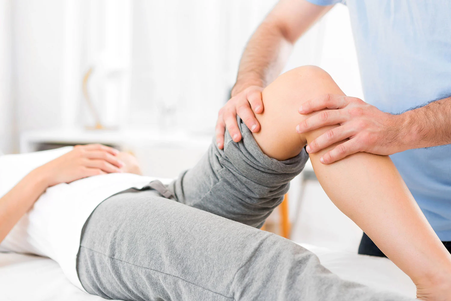 Osteopath assessing a patient during treatment in Colchester